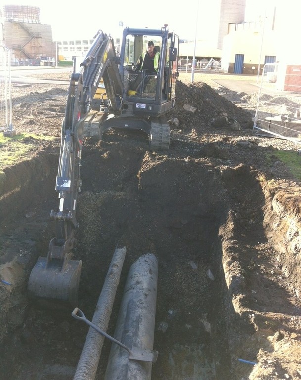 Excavator digging a trench