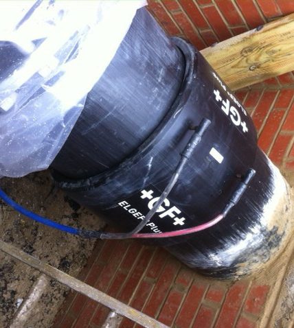 Black barrel with hoses