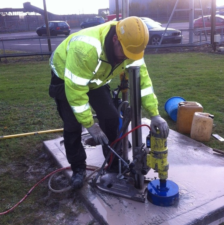 Worker using drilling equipment