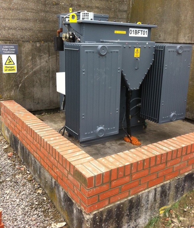 Electrical transformer on concrete base