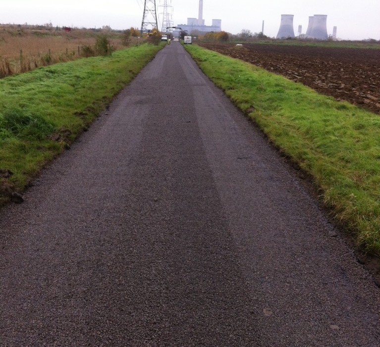 Paved road among fields