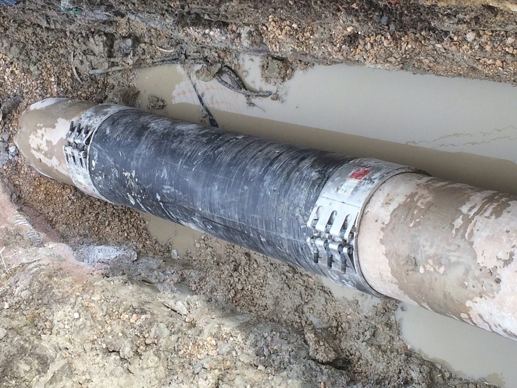 Buried pipe in muddy trench