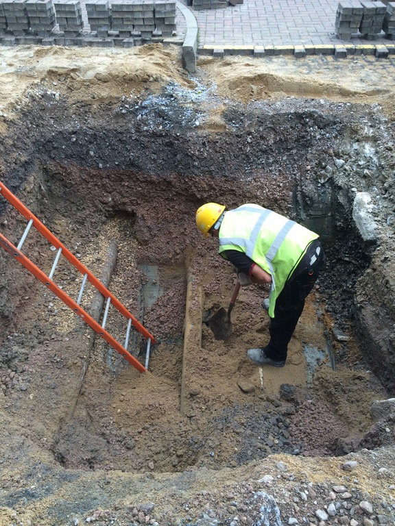 Construction worker digging trench