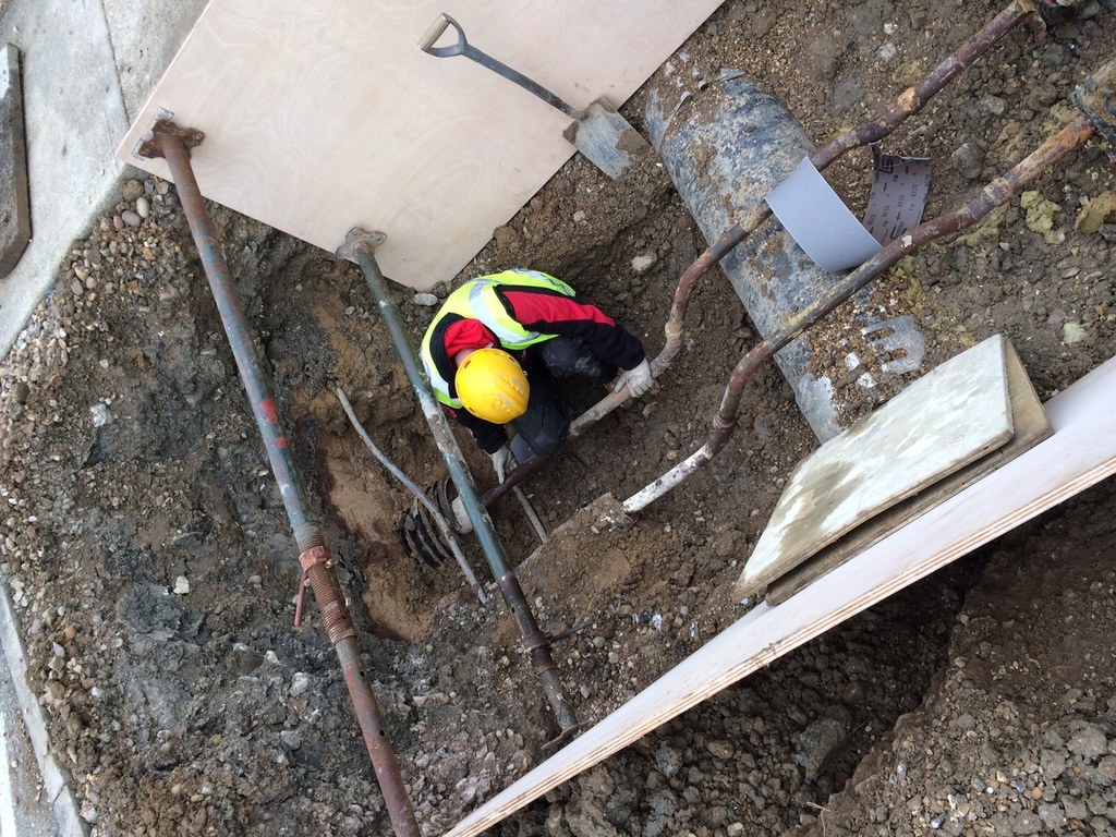 Construction worker digging trench