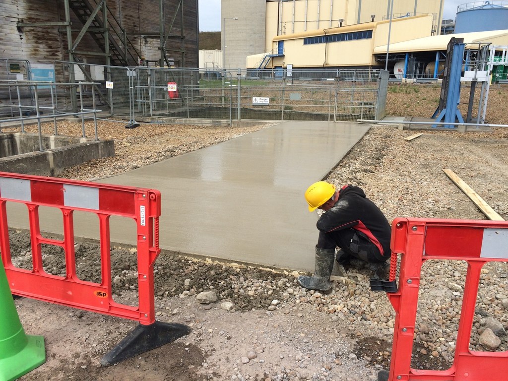 Construction worker on concrete path