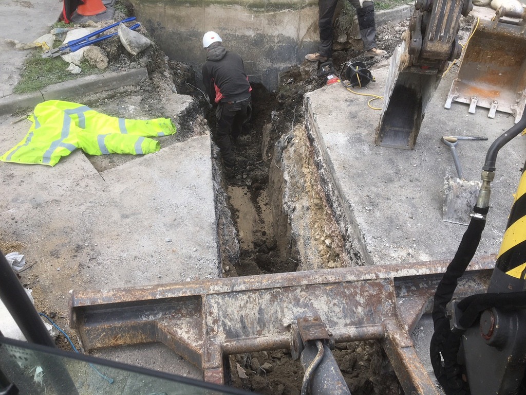 Construction workers digging trench