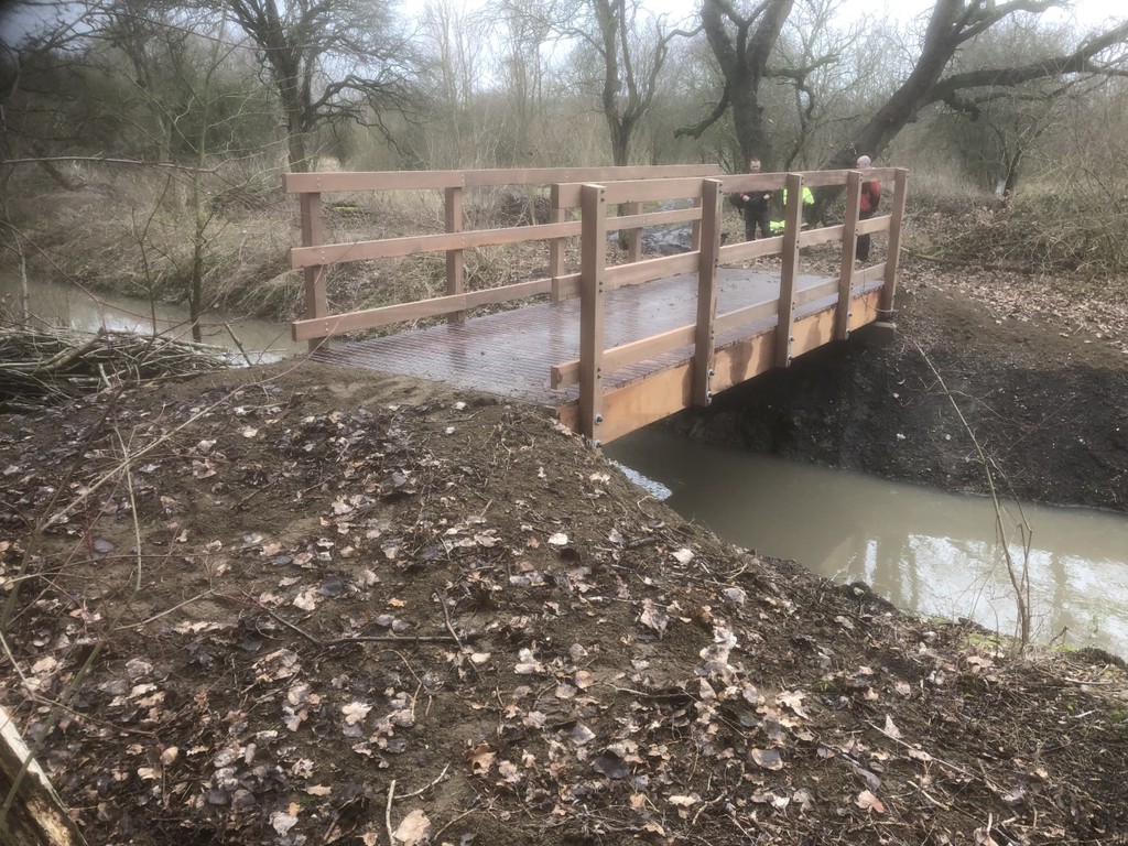 Wooden bridge over shallow creek