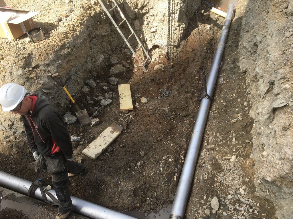 Construction worker near pipe trench