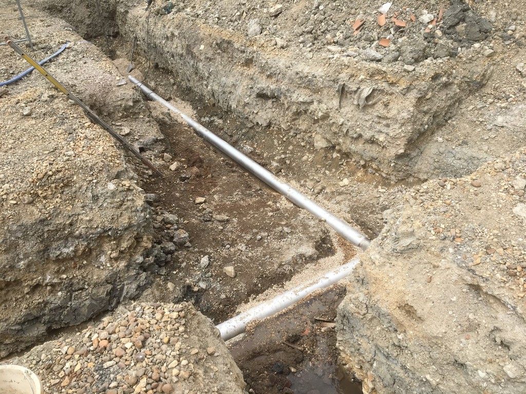 Excavated trench with pipes