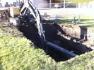 Excavator digging a trench