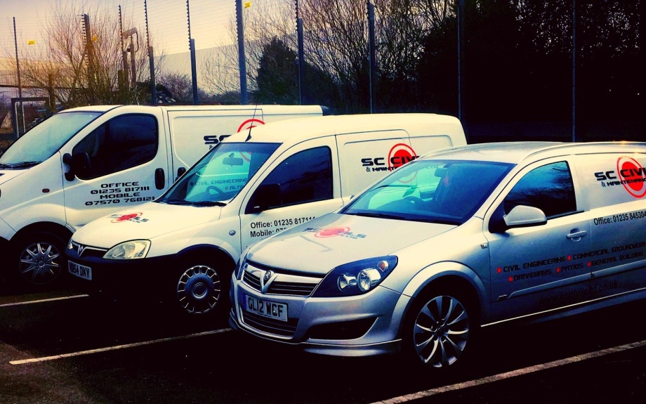 Three parked company vehicles